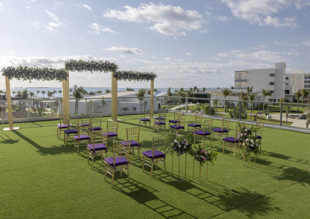 rooftop wedding ceremony in golden with lots of purple accents and purlpe flowers