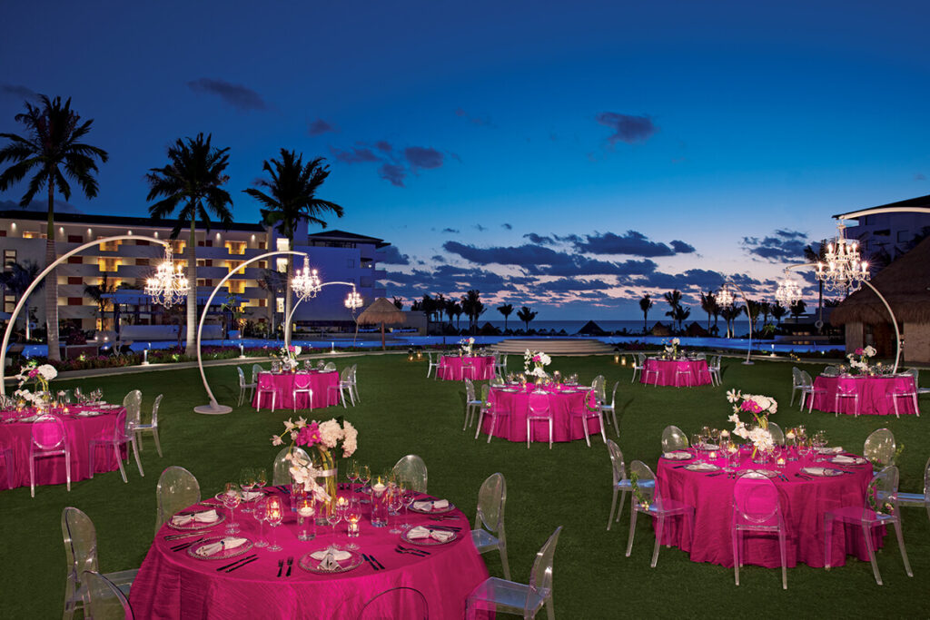 colorful fuchsia garden reception at dusk, dreams playa mujeres hotel