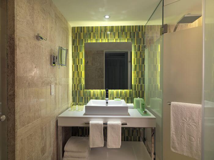 green mirror and sink area in the junior suite paradisus los cabos