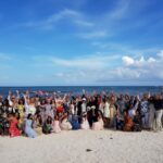large wedding group on the beach at palladium colonial
