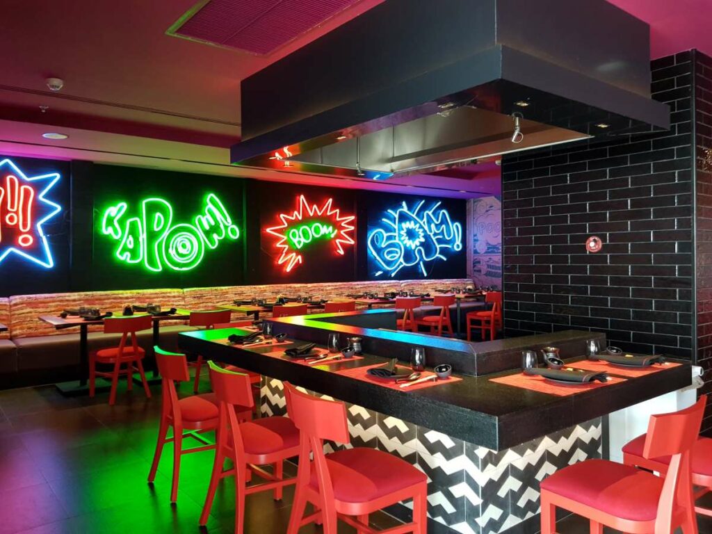 japanese restaurant with neon signs and anime cartoons at the dreams natura resort