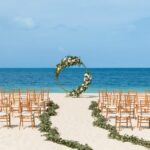 beach ceremony with gold tiffany chairs Excellence Playa Mujeres weddings
