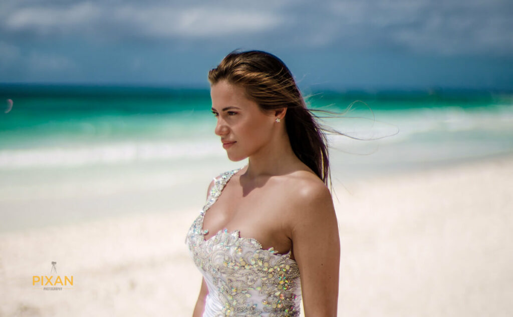 bride with asymmetrical gown with the ocean in the background