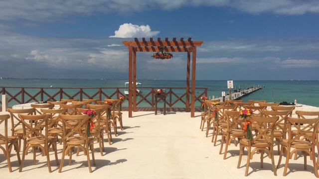 Destination wedding ceremony with crossback wooden chairs at the firepit wedding location hyatt ziva cancun