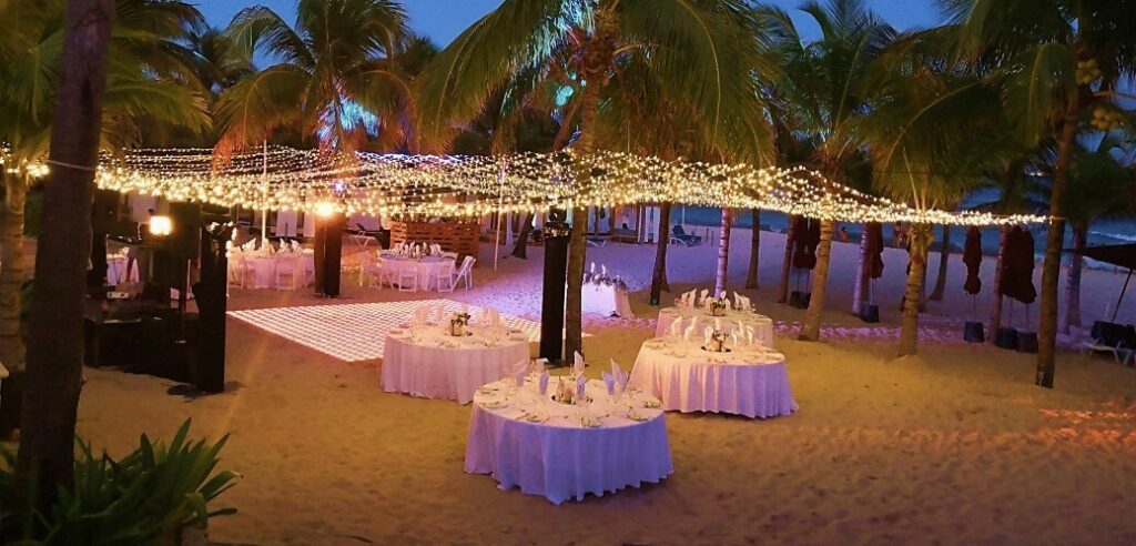 beach reception with dance floor and string lights at the fives beach hotel playa del carmen