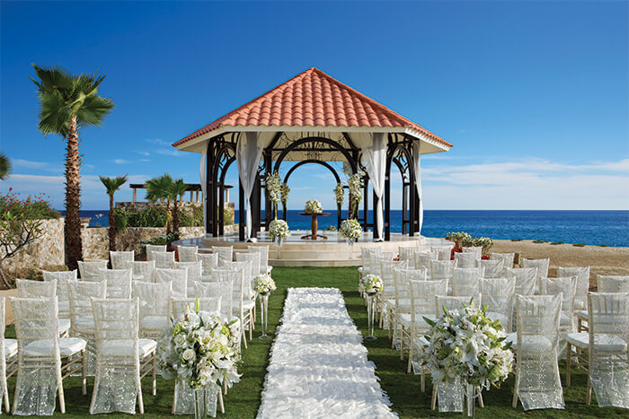 Destination wedding set-up at the ocean view wedding gazebo and tiffany chairs with covers at Secrets Los Cabos