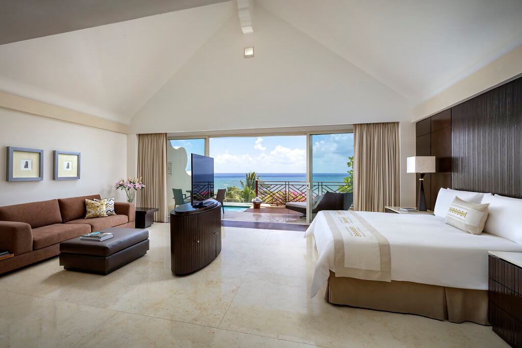 room interior iwth king bed and integrated living area, grand velas riviera maya