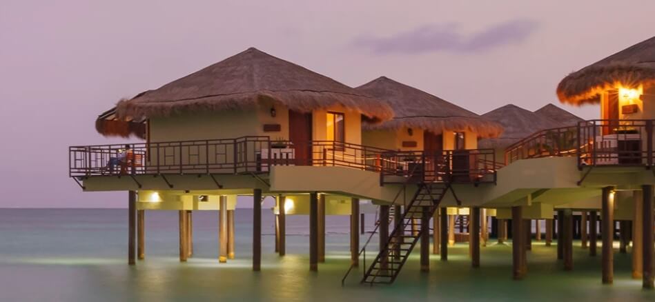 Superb over the water bungalows at Palafitos all-inclusive honeymoon resort at dusk