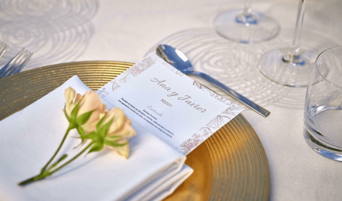 Wedding table setting with menu and flowers