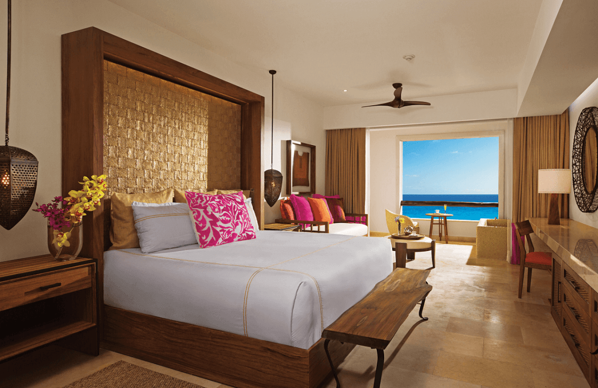 Room with king size bed and ocean front view