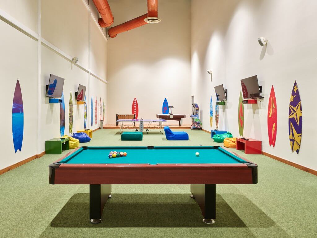 Kids playroom with screens and game tables