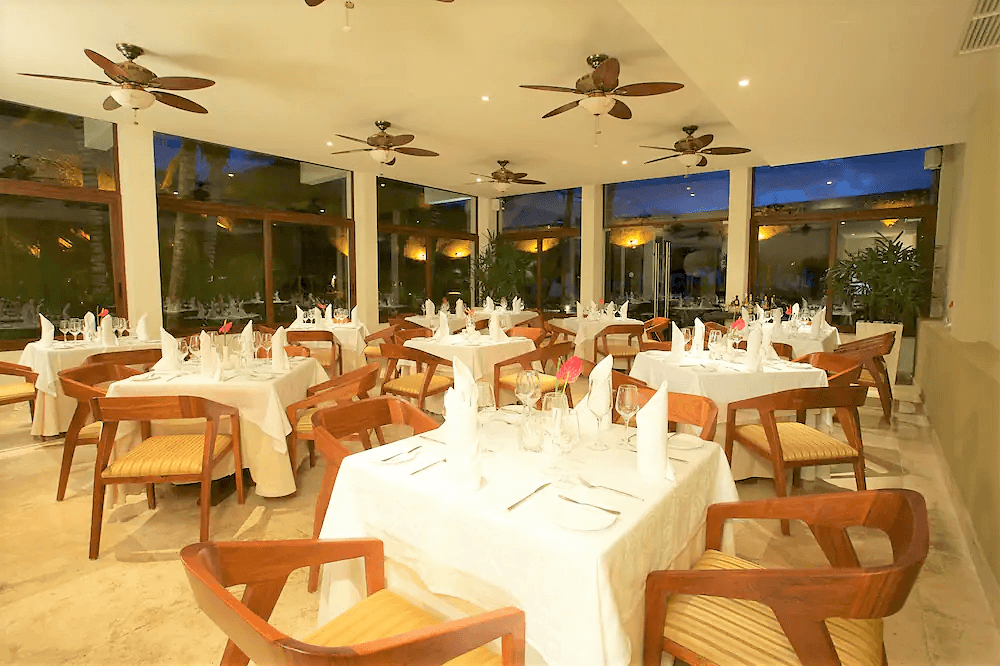 Hotel restaurant with large windows during sunset