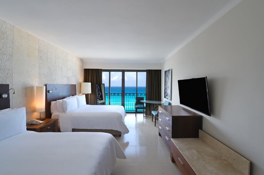 Modern and spacious room with two double size beds and ocean view