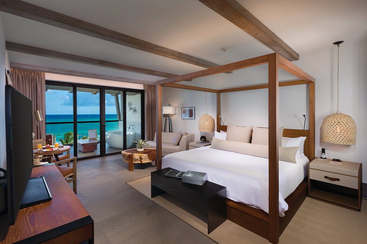 hotel room with king size bed and ocean view from the balcony