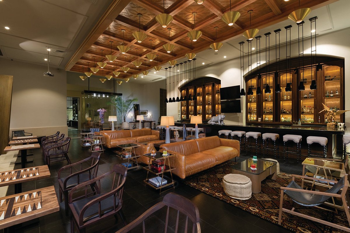 hotel bar with leather chairs and game tables