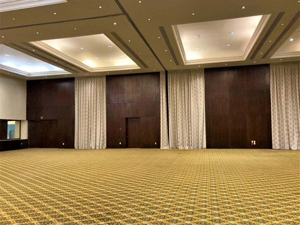 Large ballroom with wooden walls and large courtains