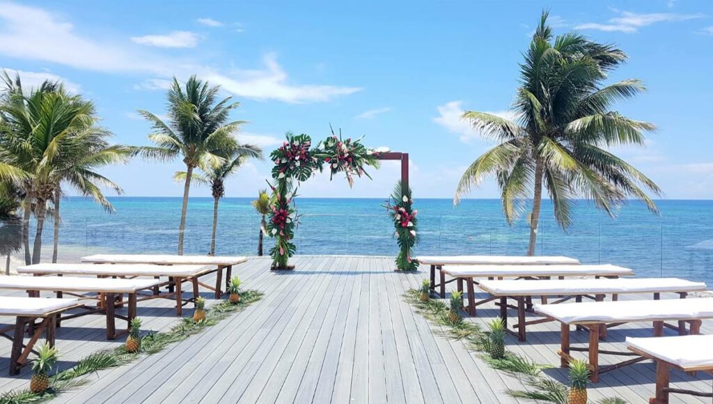Rooftop terrace set with a wooden wedding gazebo with tropical flowers