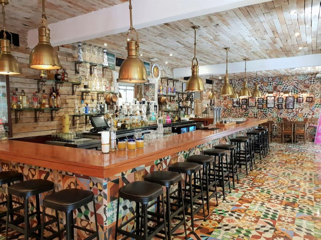 Mexican cantina with colorful tiles and golden lamps