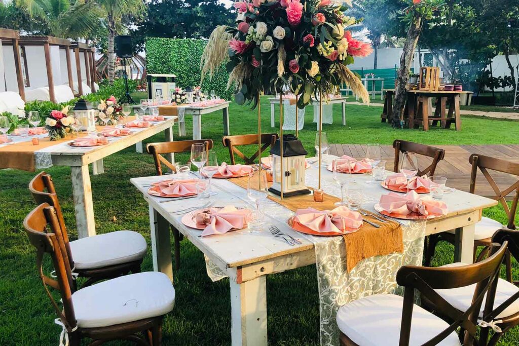 Wedding set up at the garden with pink flowers and napkins