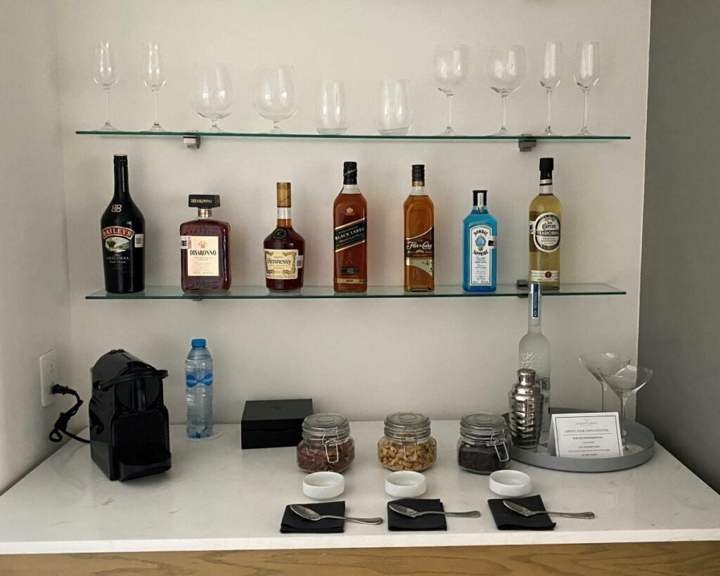 Complete VIP in-room bar with premium liquoir bottles and coffee machine