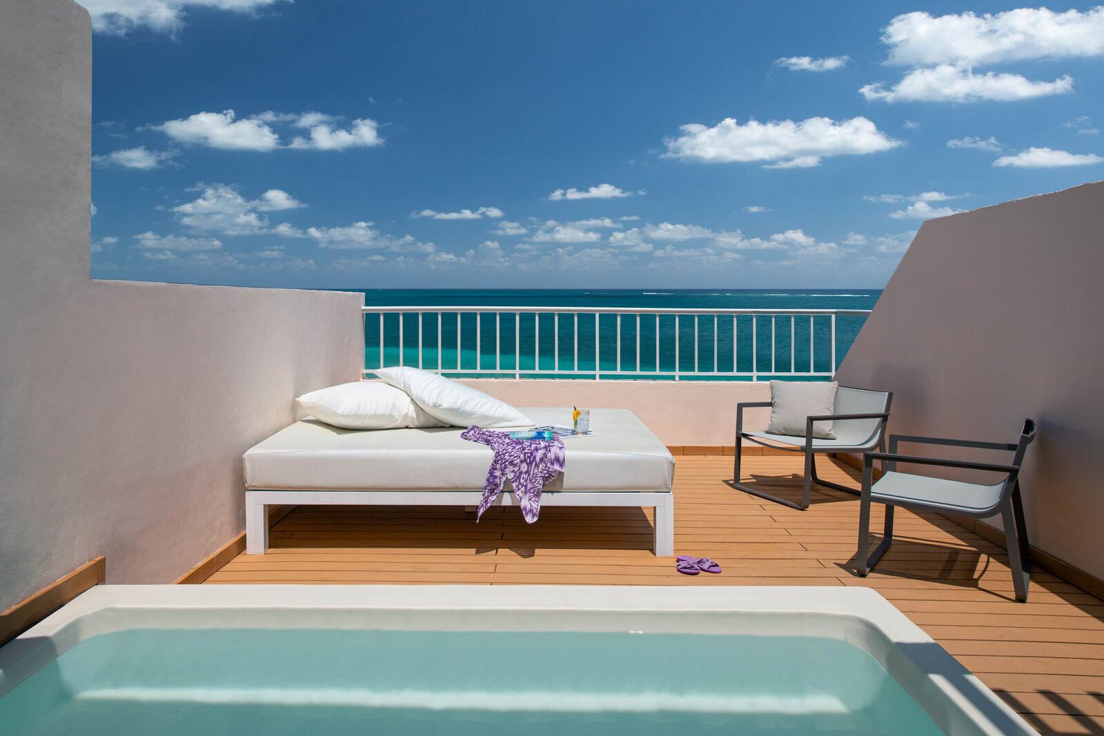 Room rooftop terrace with large jacuzzi and day bed with ocean view