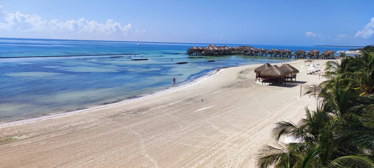 Caribbean beach with over the water bungalows at el dorado maroma wedding resort