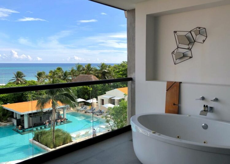 Hotel room balcony with ocean view and a large bathtub