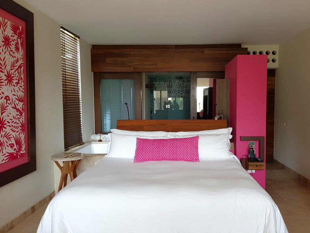 Hotel room with lots of wood and pink accents