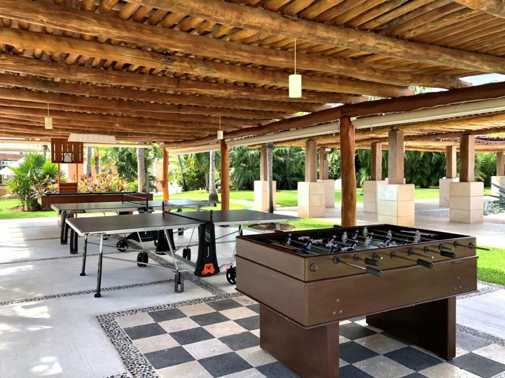 Game tables in a garden with stick roof