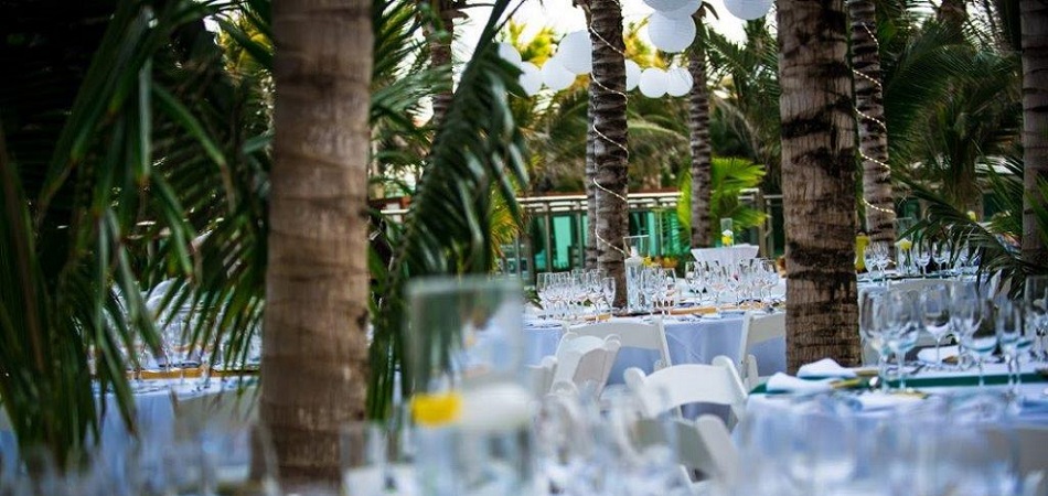 wedding set up in a pool deck with lots of palm trees