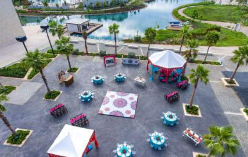 Wedding plaza with palm trees and a south asian wedding event