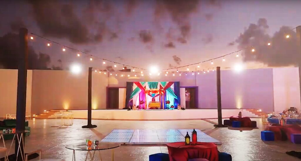 South asian wedding set in a large terrace with bistro lights and a led dance floor
