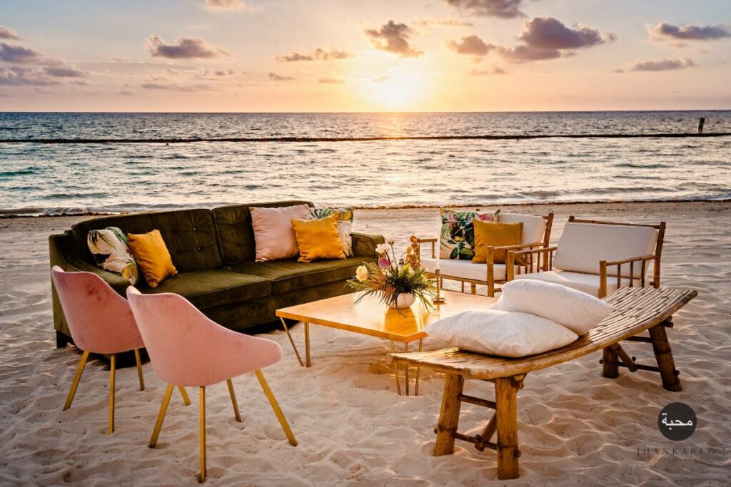Sunset cocktail setting on the beach with lounge furniture