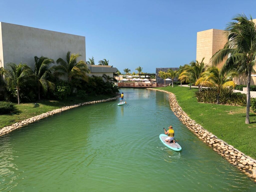 Two guests paddling on the water canals