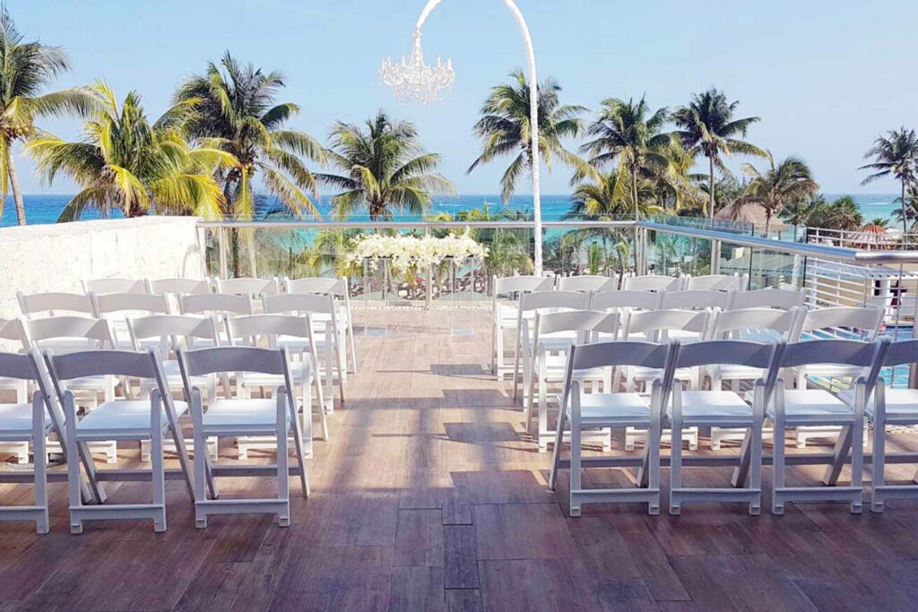Sky deck with a wedding set up with white chairs and white flowers