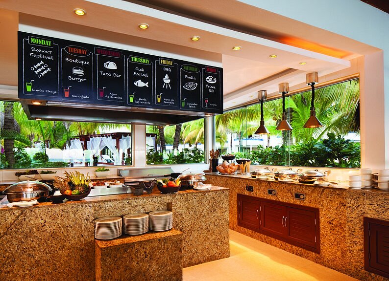 Buffet restaurant with food display and food menu on the wall