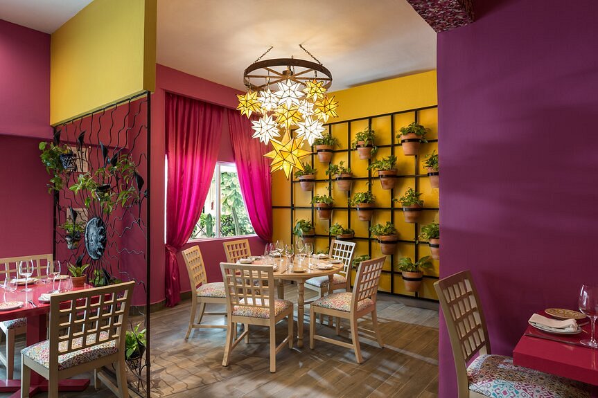 Colorful mexican restaurant with hanging pots and hanging star chandelier