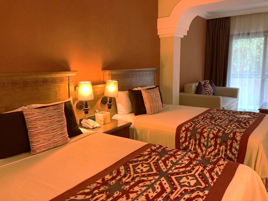 Hotel room with two double beds decorated with bright warm colors