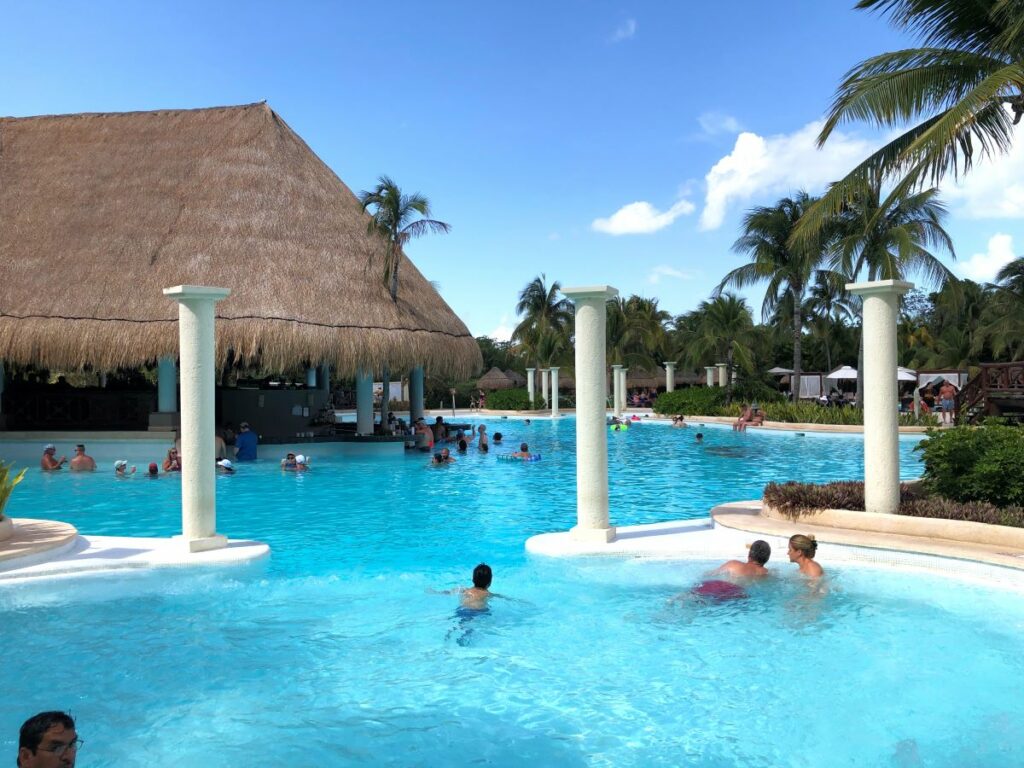 Beach resort pool with a swim up bar palapa