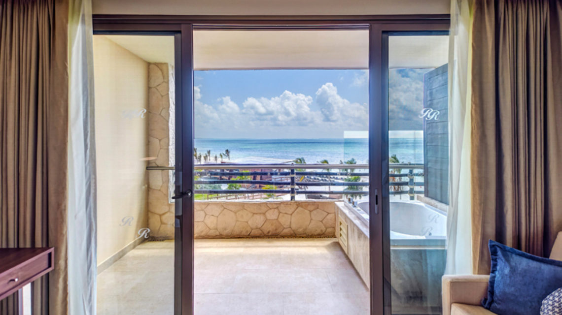 Hotel room balcony with ocean view and a jacuzzi outside