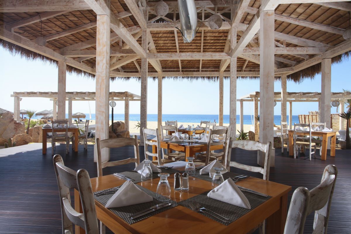 Beach restaurant with ocean view and wooden palapa roof