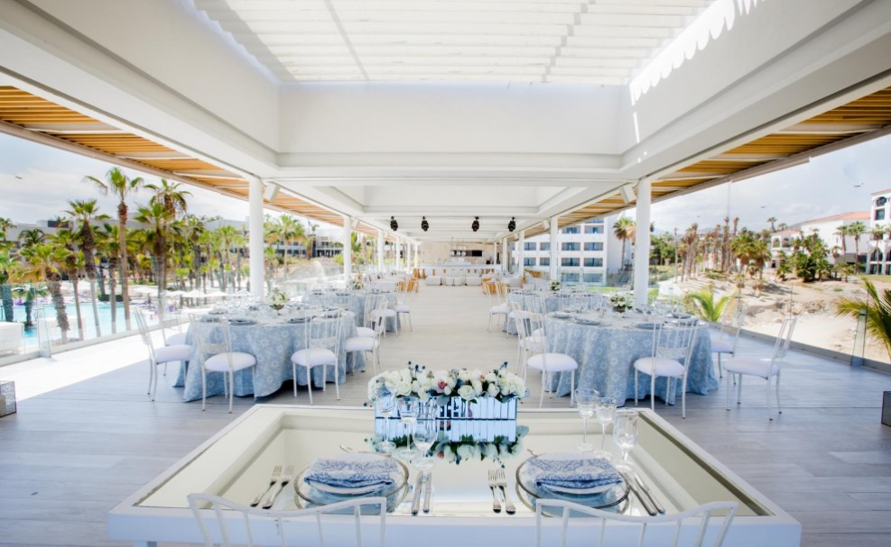 resort wedding at the covered terrace with blue and white tables and chairs