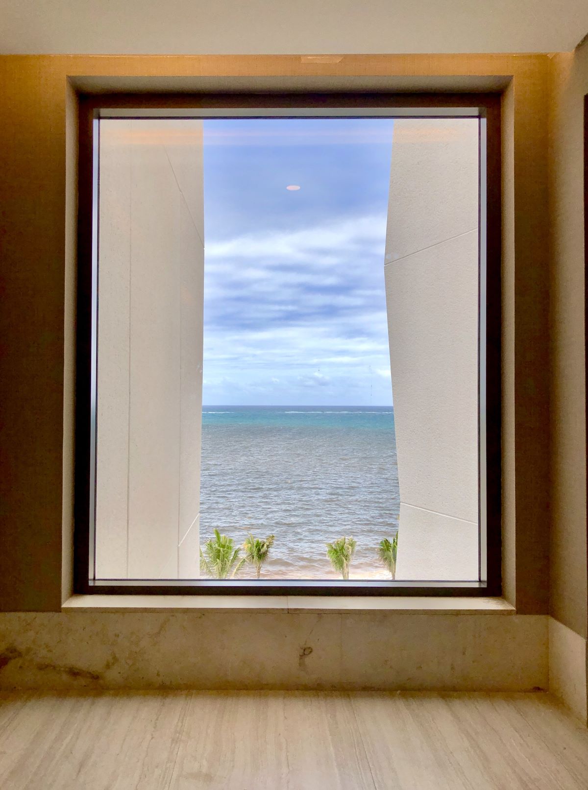 Hall window overlooking the ocean and palmtrees