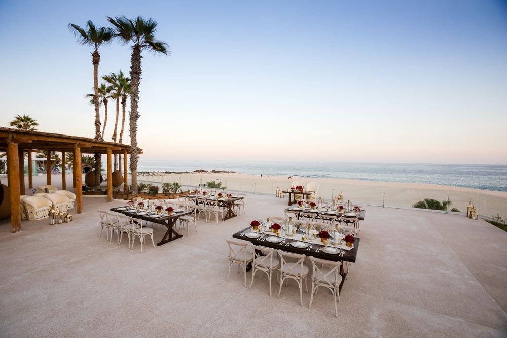 resort wedding with wooden furniture and sunset in the background