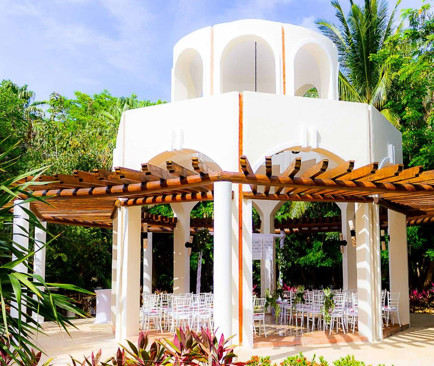 Destination Wedding ceremony set-up a the Valentin imperial riviera maya gazebo with octagonal shape and wooden roof with white chairs