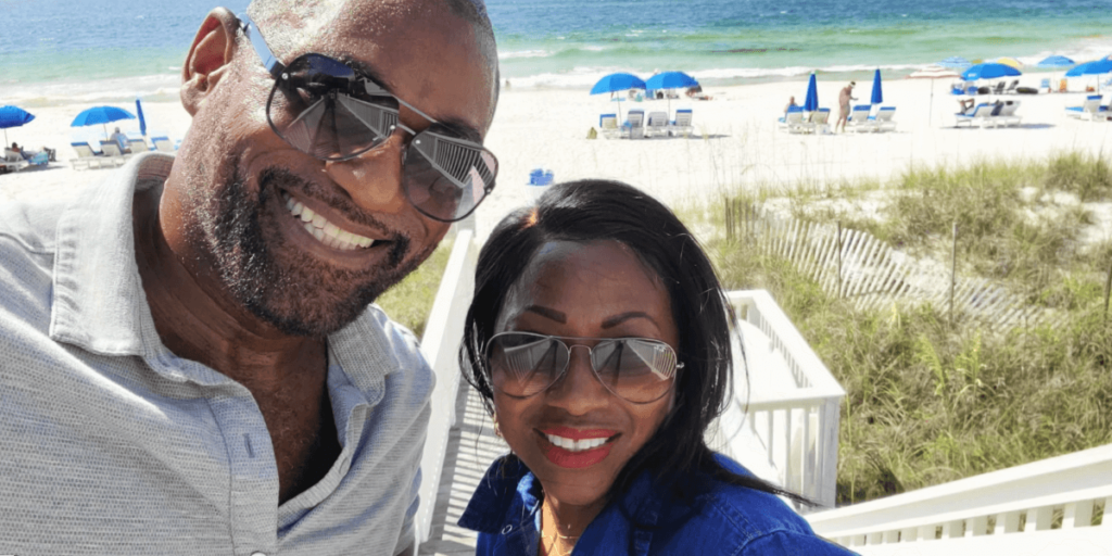 african american couple with sunglasses taking a selfie at the beach