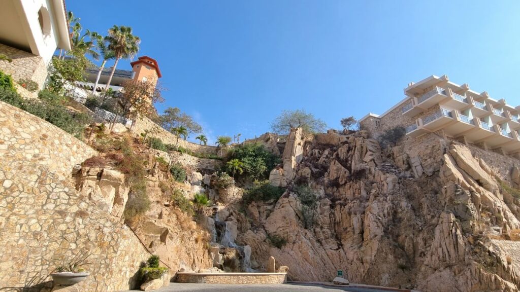 Cliff with hotel rooms on it and a water fall