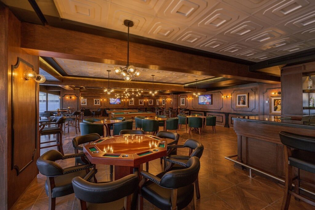 dark wooden bar with poker tables and leather furniture
