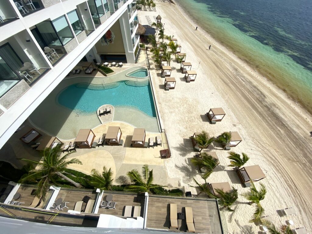 aerial beach view of a hotel in puerto morelos with an infinity pool