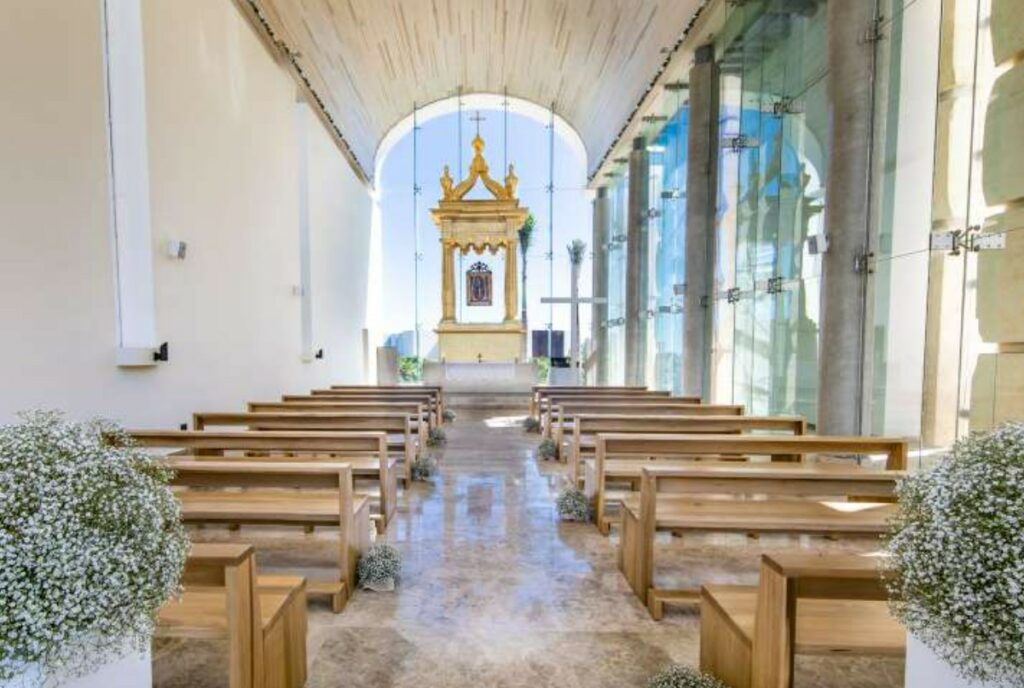 catholica chapel with glass walls and wooden benches